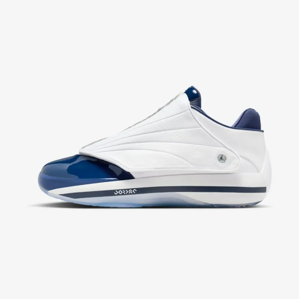 Air Jordan 4016 “Midnight Navy” shown in a lateral side view with the quilted shroud fastened, featuring a smooth white leather upper, sculpted paneling, glossy midnight navy patent leather toe cap, navy collar lining, and a white midsole with a dark accent stripe on a clean white background