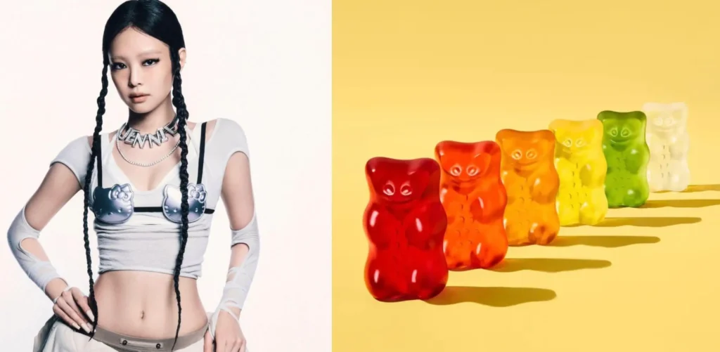 Side-by-side image showing BLACKPINK’s Jennie styled in a sleek braided look with a silver Hello Kitty top and nameplate necklace on the left, paired with a row of colorful HARIBO gummy bears lined up on a pastel yellow background on the right, highlighting the playful contrast between K-pop fashion and candy culture