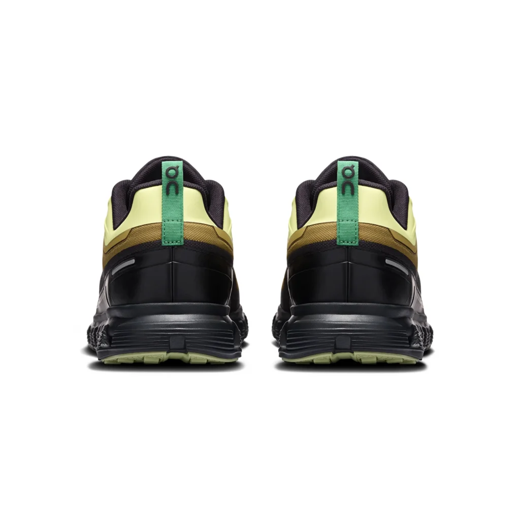 Rear view of the ON Cloud 6 Geo Waterproof sneakers in the Limelight · Safari colorway, highlighting the green heel pull tabs, padded collar, layered waterproof construction, and CloudTec midsole designed for stability and all-weather urban use