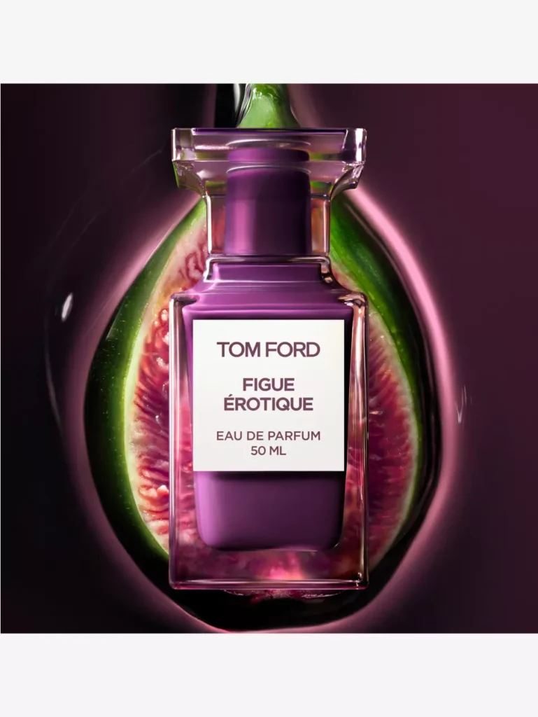 Tom Ford Figue Érotique Eau de Parfum 50ml bottle centered against a dark backdrop, with a ripe fig sliced open behind it, highlighting the fragrance’s deep plum hue and sensual fig-inspired composition