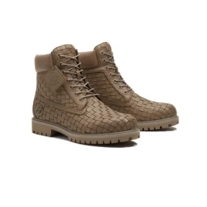 Timberland Men’s Textured Premium 6-Inch Boots in khaki-toned woven full-grain leather, featuring a padded ankle collar, lace-up closure, embossed Timberland logo, and rugged lugged rubber outsole, shown in a clean studio setting