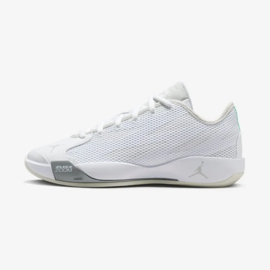 Side view Jordan Luka .77 “Pure Money” basketball shoe shown in a medial side profile, featuring a white mesh upper, tonal Jumpman logo on the heel, visible Air Zoom cushioning at the forefoot, and a low-profile outsole in a clean monochrome finish