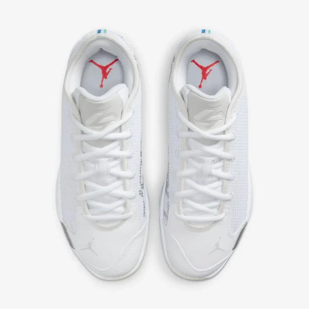 Top-down view of the Jordan Luka .77 “Pure Money” basketball shoes, highlighting the white mesh uppers, tonal laces, padded tongues with Luka Dončić logo, and red Jumpman branding on the insoles against a clean white background