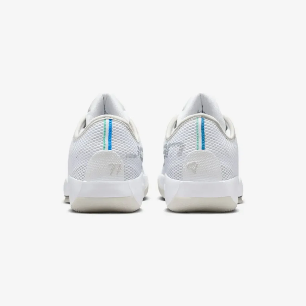 Rear view of the Jordan Luka .77 “Pure Money” basketball shoes, showing the white textured mesh heels, tonal Jumpman logos, subtle heel tabs, and vertical blue-and-green accent stripes referencing Luka Dončić’s signature detailing
