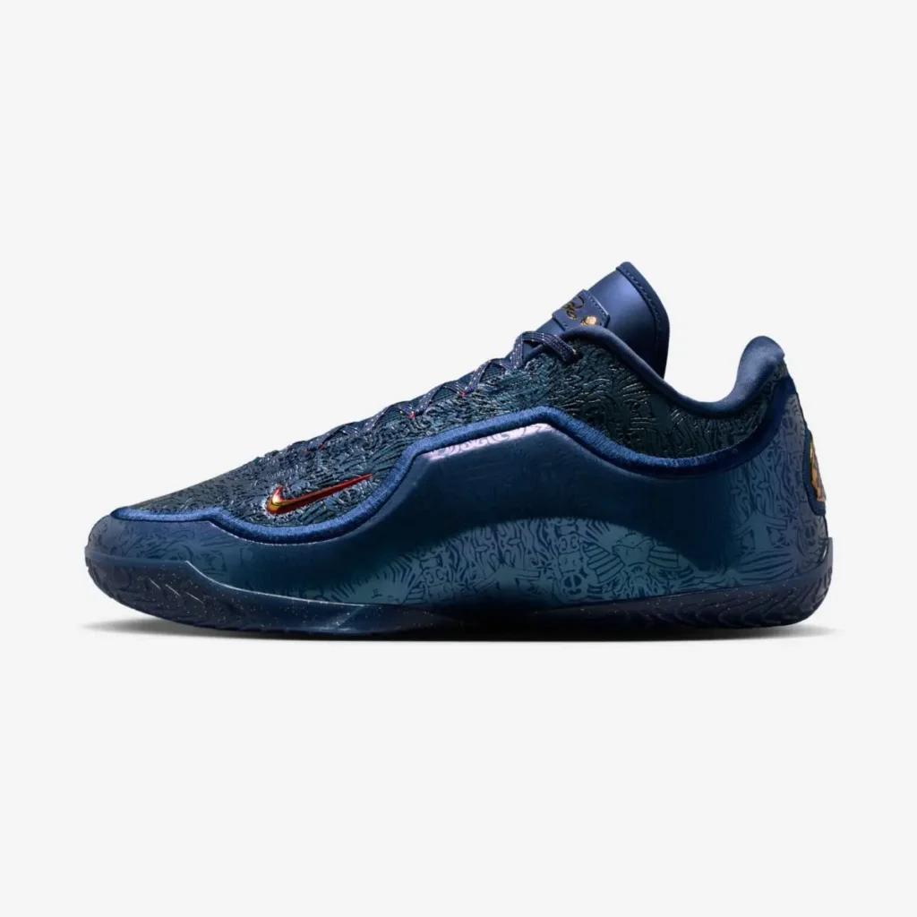 Side profile of the Nike LeBron 23 “Out For Redemption” basketball shoe in dark navy with embossed graphic detailing across the upper and midsole, metallic red-and-gold Swoosh, padded collar, and speckled black outsole on a white background