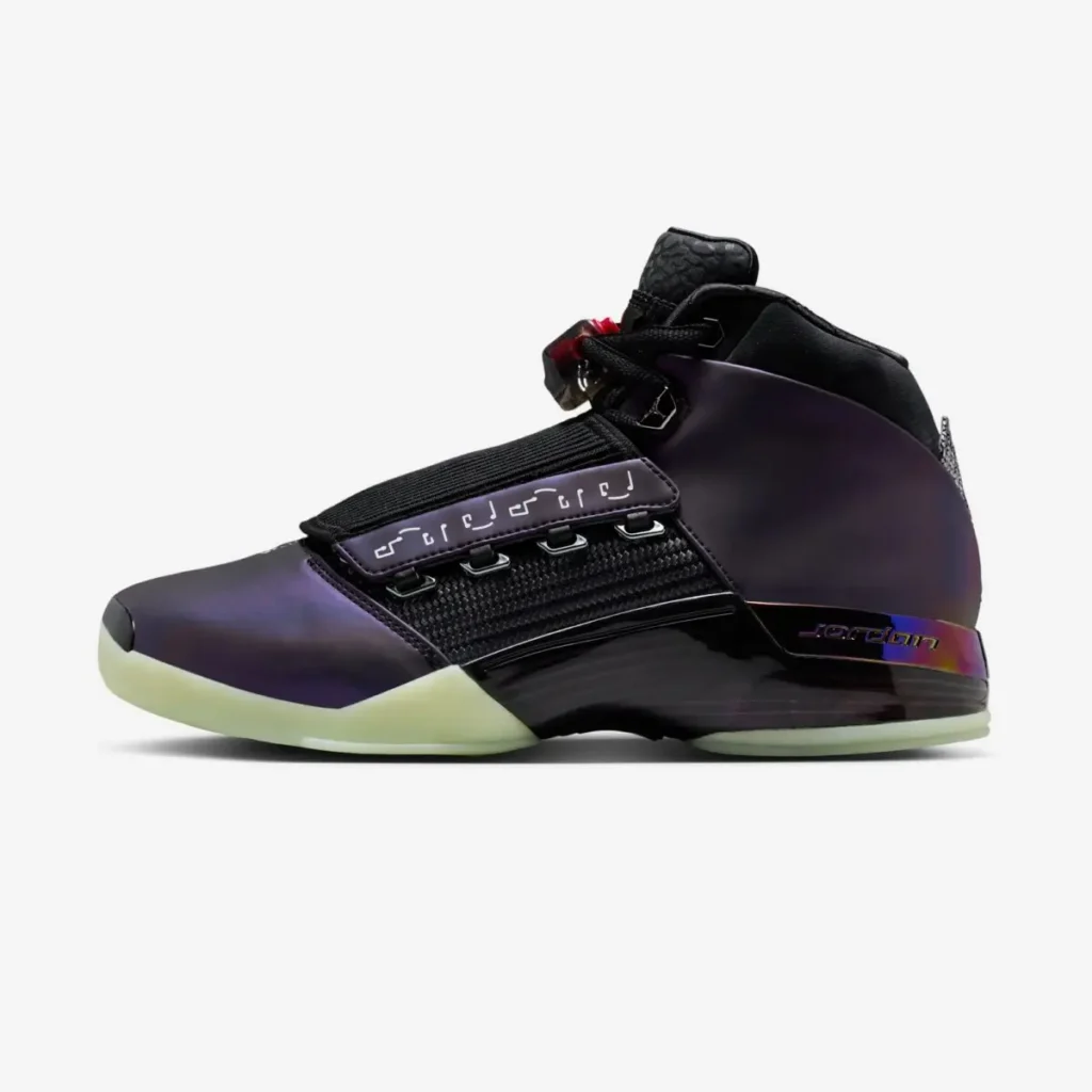 Side profile of Zach Rumbaugh’s Air Jordan 17 “Doernbecher Freestyle,” showcasing a deep purple color-shifting upper, black mesh midfoot panel, adjustable strap with graphic detailing, sculpted black midsole, and glow-in-the-dark green outsole against a white background