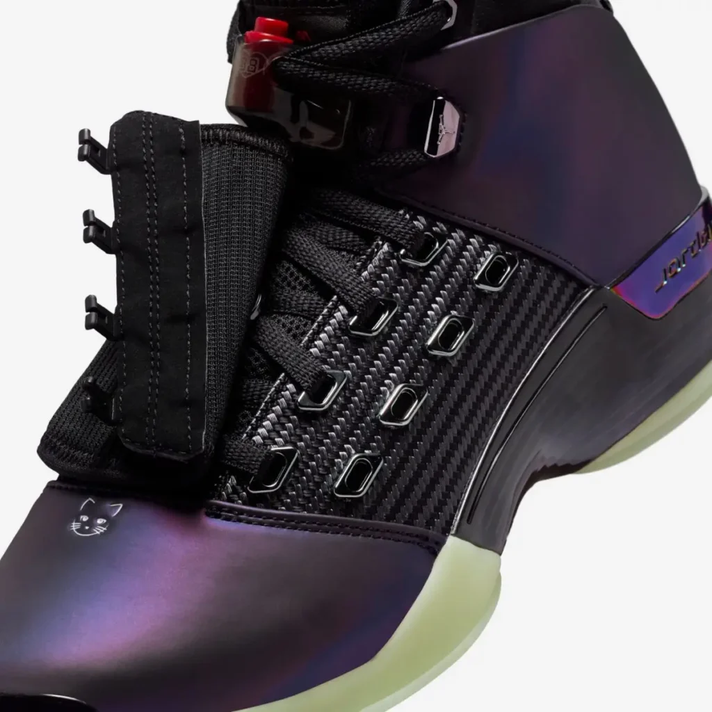 Detailed close-up of Zach Rumbaugh’s Air Jordan 17 “Doernbecher Freestyle,” focusing on the carbon-fiber-style woven midfoot panel, black lace loops, adjustable strap hardware, color-shifting purple upper with a small cat graphic on the toe, and glow-in-the-dark green outsole edge