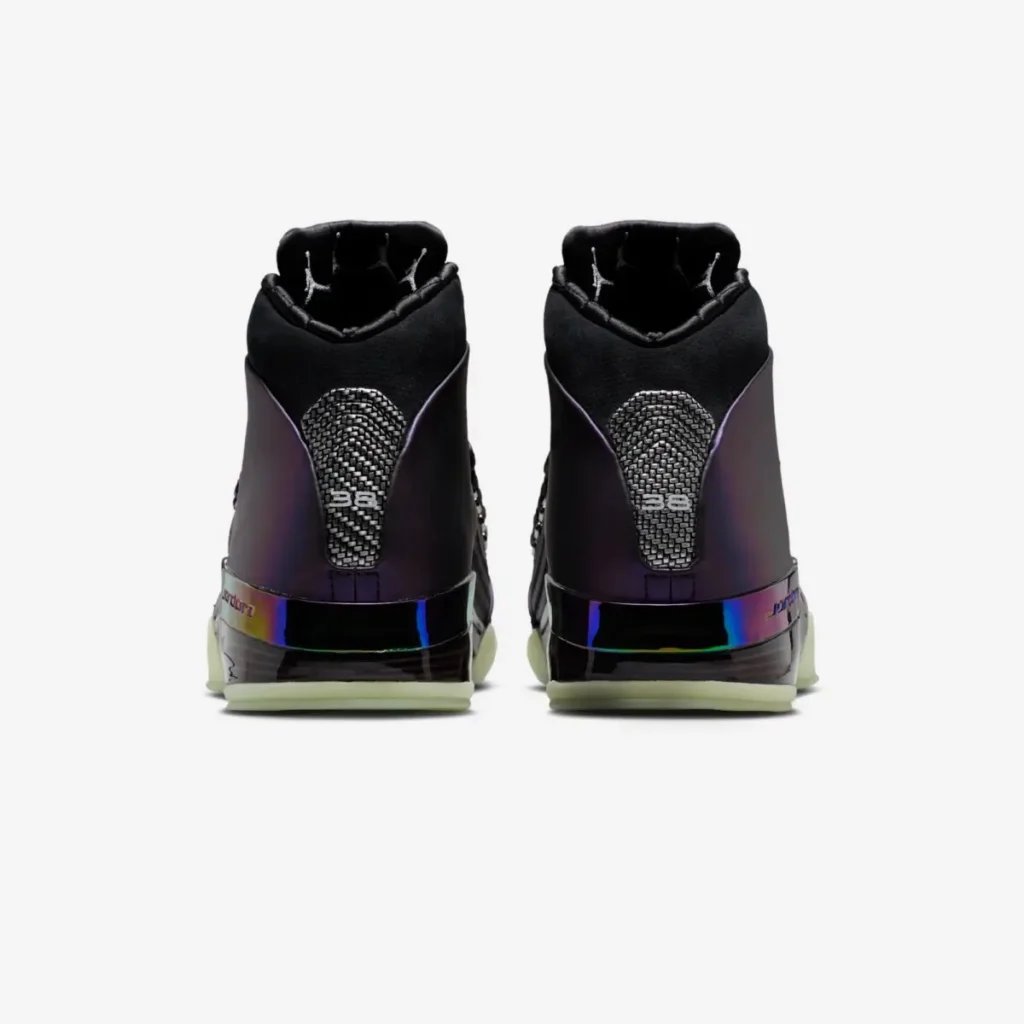 Rear view of the pair of Zach Rumbaugh’s Air Jordan 17 “Doernbecher Freestyle” sneakers, showing the color-shifting purple heel panels, carbon-fiber-style heel insert with “38” detailing, iridescent Jordan branding on the midsole, and glow-in-the-dark green outsole