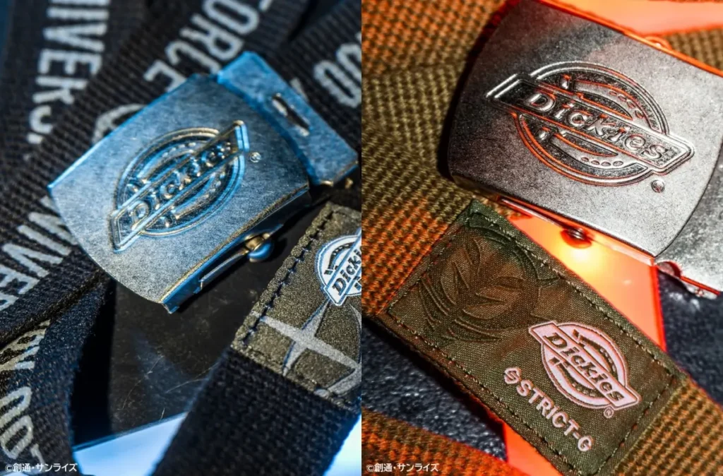 Close-up of belt buckles and woven tags from the Dickies × Mobile Suit Gundam collection showing metallic Dickies hardware and co-branded fabric labels in blue- and red-lit studio settings