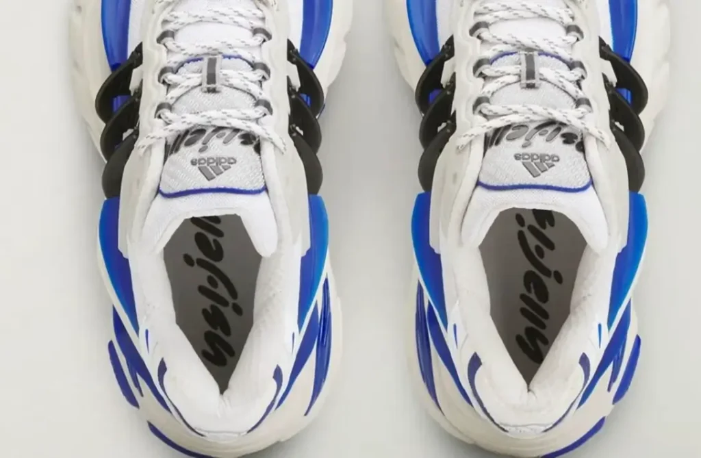 Top-down view of the adidas Jellyfish ‘Royal’ sneakers highlighting white mesh tongues, rope laces, black structural side cages, and royal blue graphic accents with branded insoles visible inside the shoes