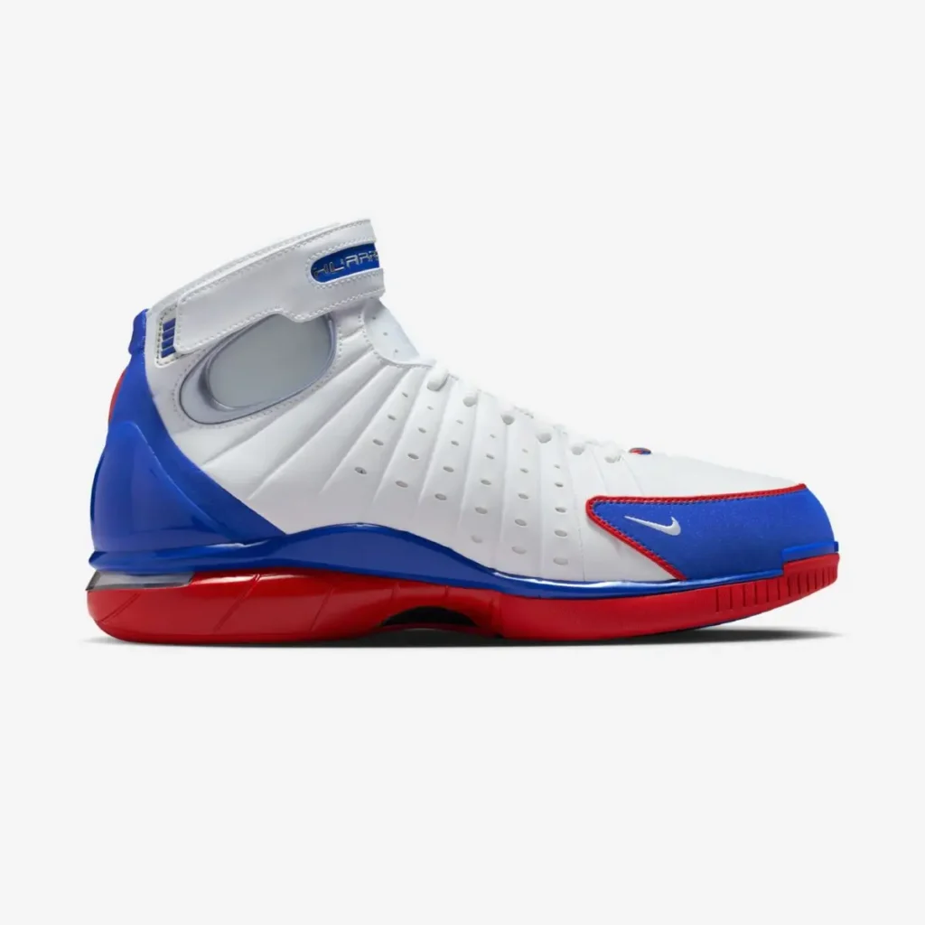 Side view of the Nike Air Zoom Huarache 2K4 “All-Star” basketball sneaker in white, blue, and red, showing the high-top design, perforated upper panels, and bold red Zoom Air midsole on a light gray background