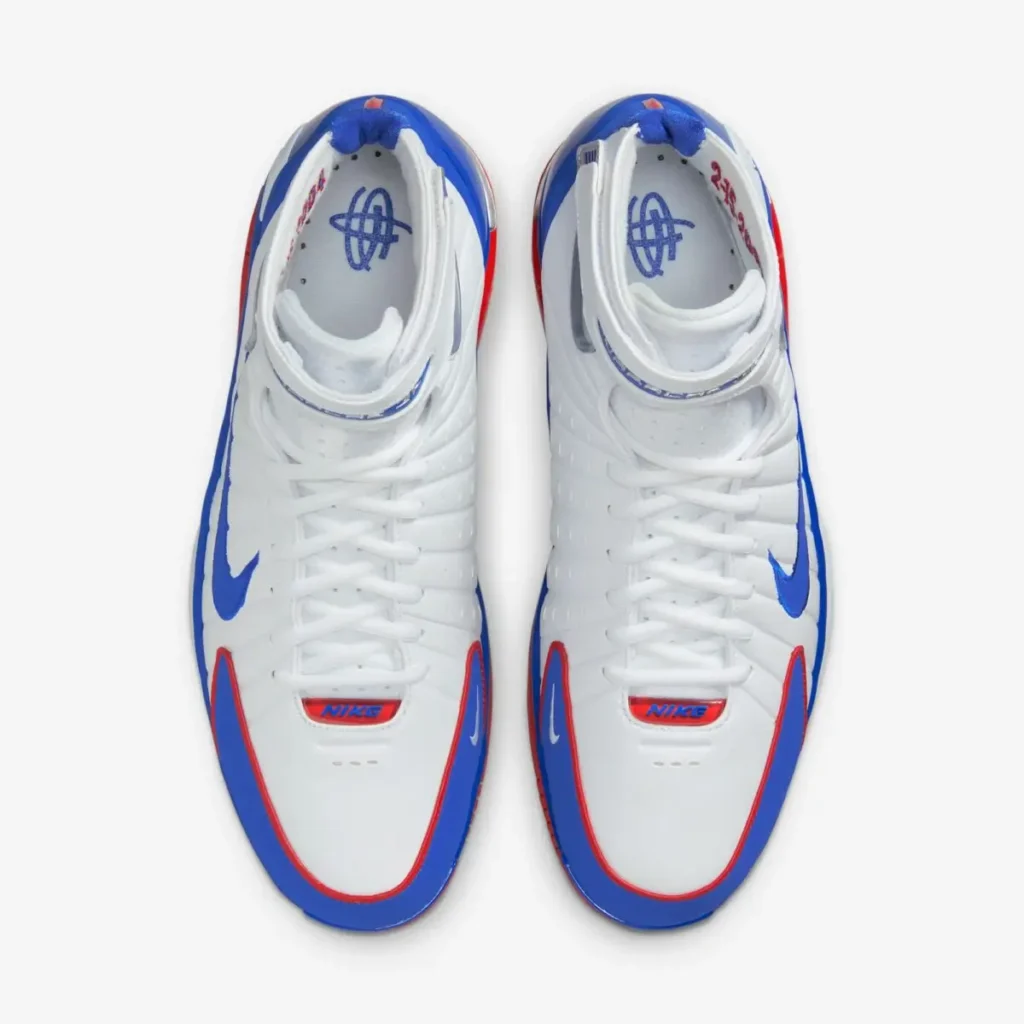 Top-down view of the Nike Air Zoom Huarache 2K4 “All-Star” sneakers in white, blue, and red, highlighting the lace-up design, perforated toe box, and signature Huarache branding inside the collar