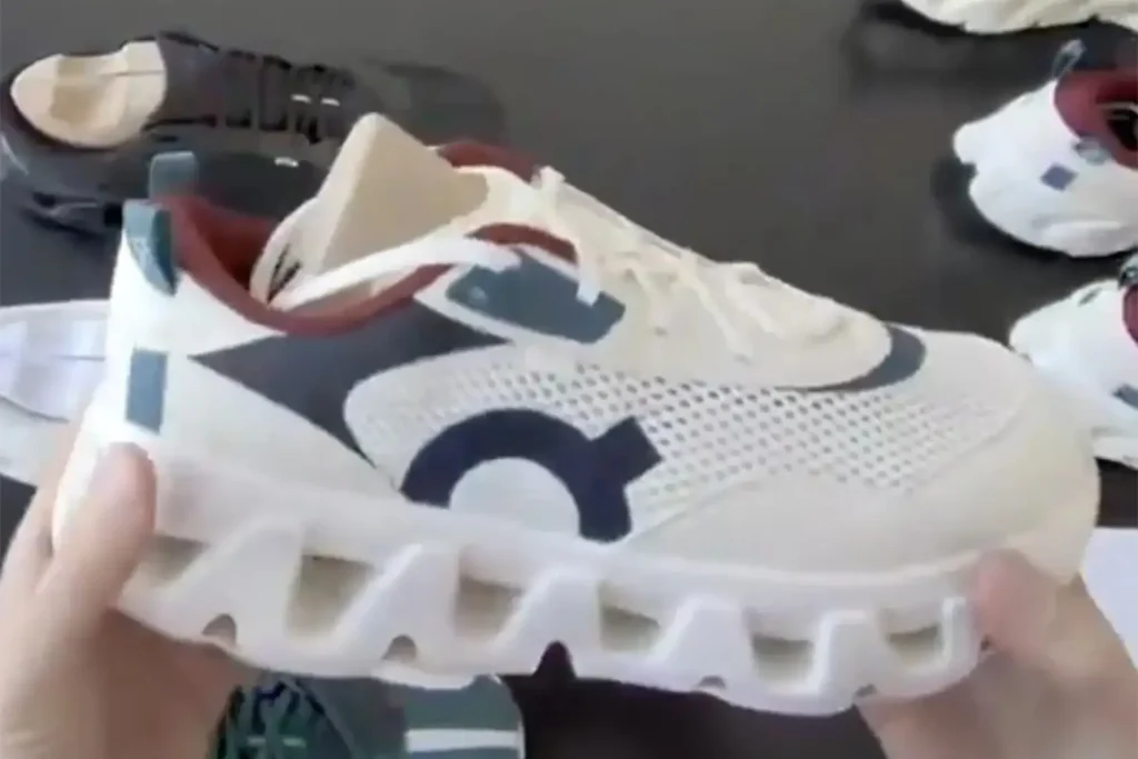 Close-up of a Kith x On Running K-Tech sneaker prototype featuring a breathable mesh upper, layered synthetic panels, and the signature CloudTec cushioned midsole
