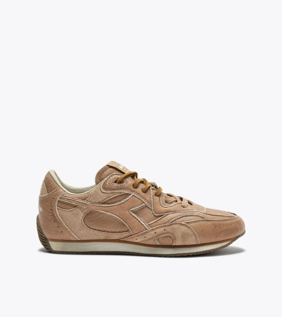 Side profile of the Diadora Equipe Revenge Dune Used Italia sneaker featuring stonewashed dune full-grain leather, layered panels, suede laces, and a vintage track-inspired rubber outsole