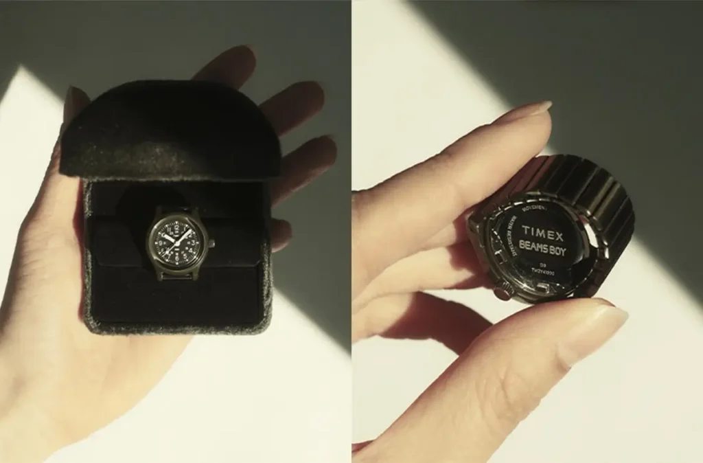 Small TIMEX Original Camper ring watch inside a black presentation case held in hand under soft directional light