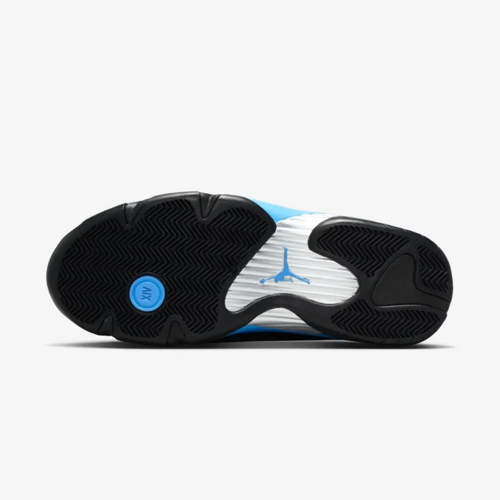 Outsole view of the Air Jordan 14 “University Blue” showing black herringbone traction pods, a silver midfoot plate with a blue Jumpman logo, and a circular blue XV emblem near the heel