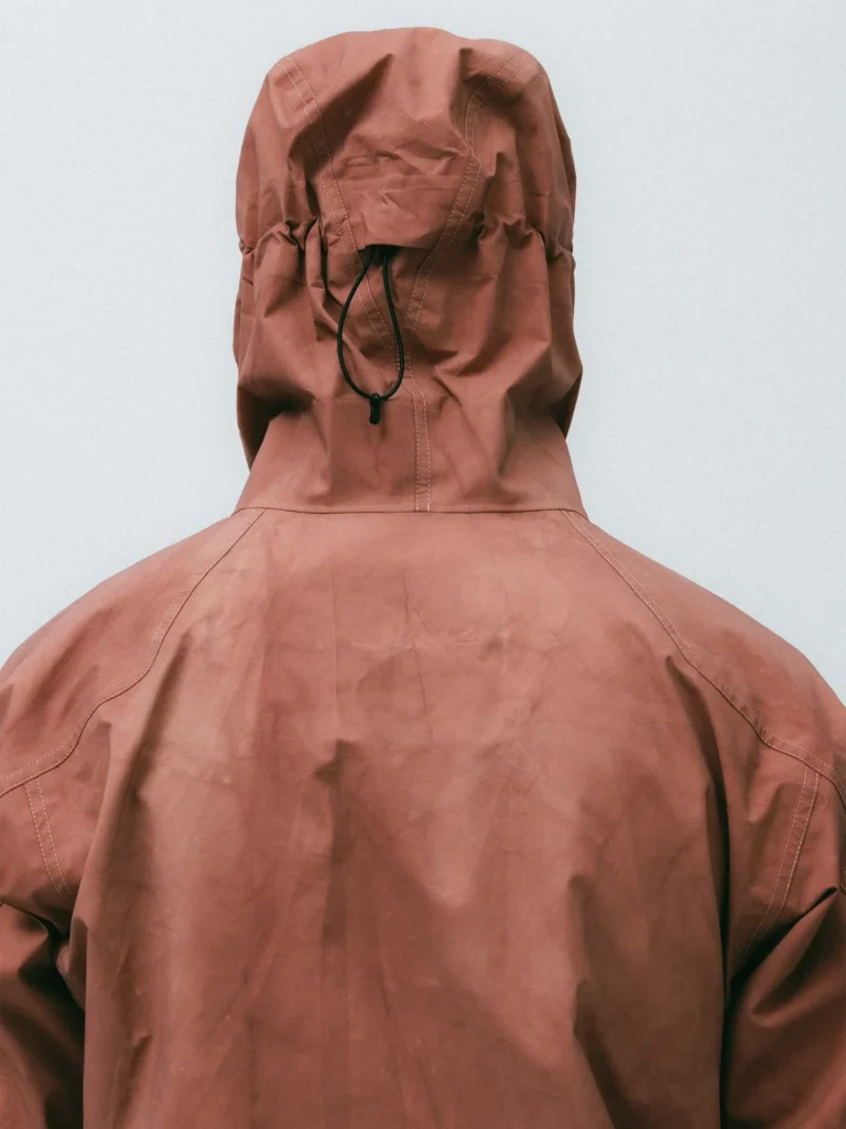 Rust colorway hand-dyed GORE-TEX jacket from the HAVEN Exploration project showing tonal variation across the hood and back panel