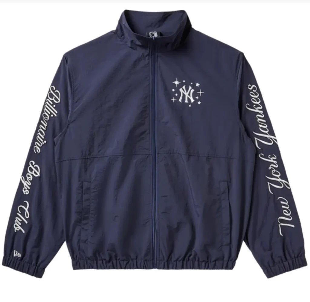 Front view of a navy zip-up windbreaker from the Billionaire Boys Club x New York Yankees collaboration, featuring a white NY logo with star motifs on the chest and script branding running down both sleeves