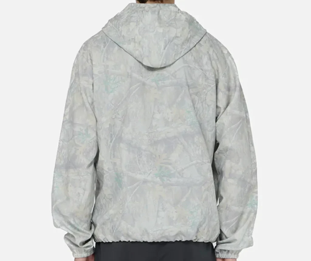 Rear view of Inverness Spray Green x Antique White hooded anorak with subtle camo-style pattern and elastic hem