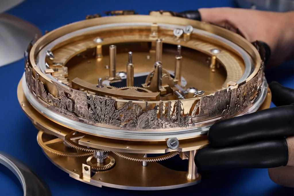 Handcrafted Louis Vuitton × De Bethune Sympathique clock mechanism with engraved gold ring depicting landscape scenes, visible gears, and watchmaker handling the assembly