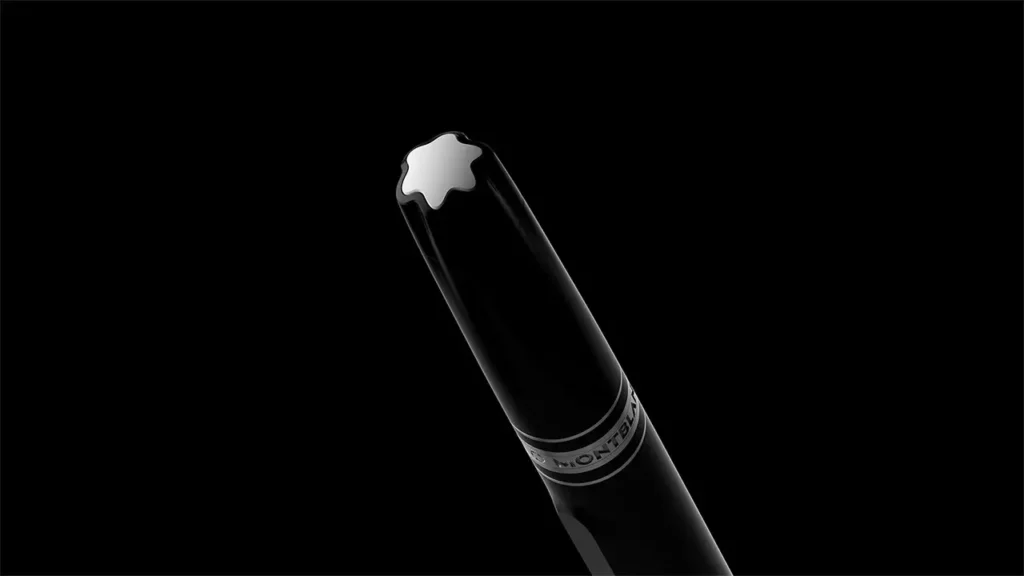 Angled view of a black Montblanc fountain pen highlighting the iconic white star emblem and engraved band