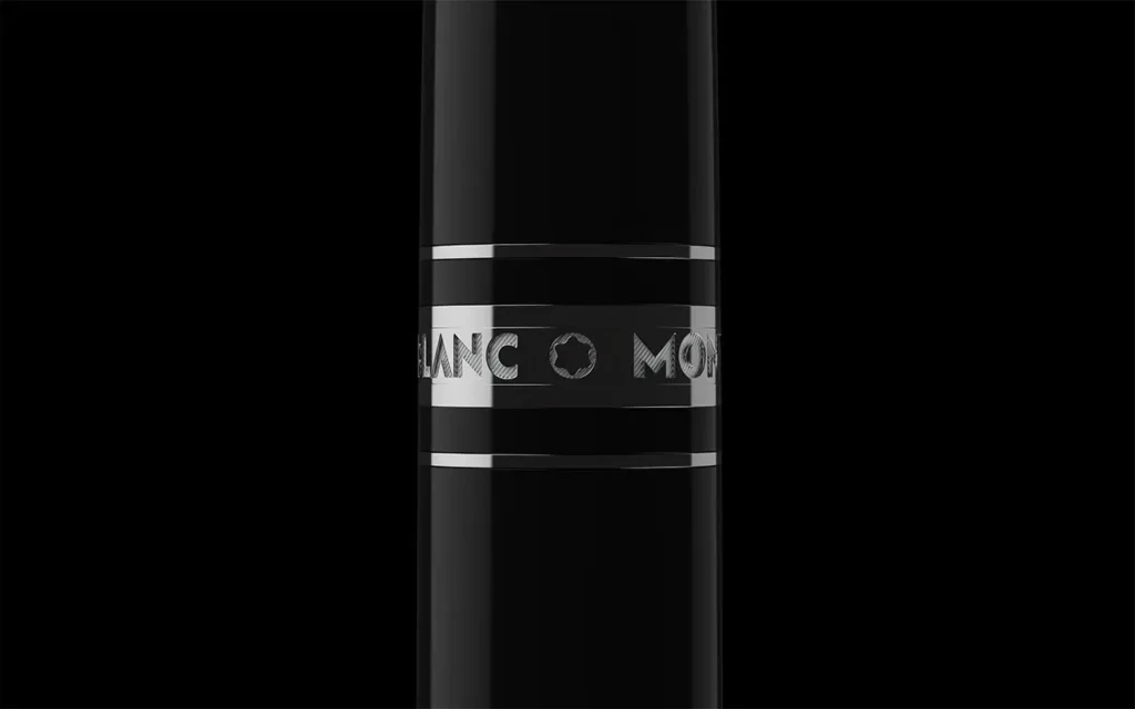 Close-up of the engraved band on a Montblanc pen, highlighting the signature logo and metal ring detail