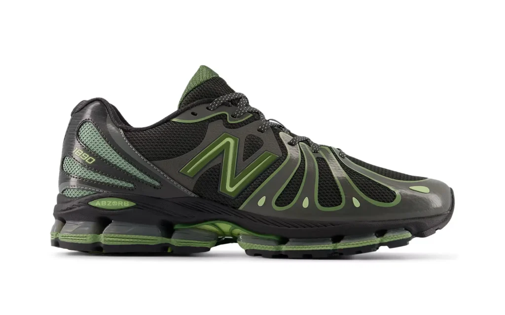 Side profile of the New Balance 1890 “Black Utility Green” sneaker, featuring breathable black mesh, flowing green synthetic overlays, oversized N logo, and segmented ABZORB cushioning along the midsole
