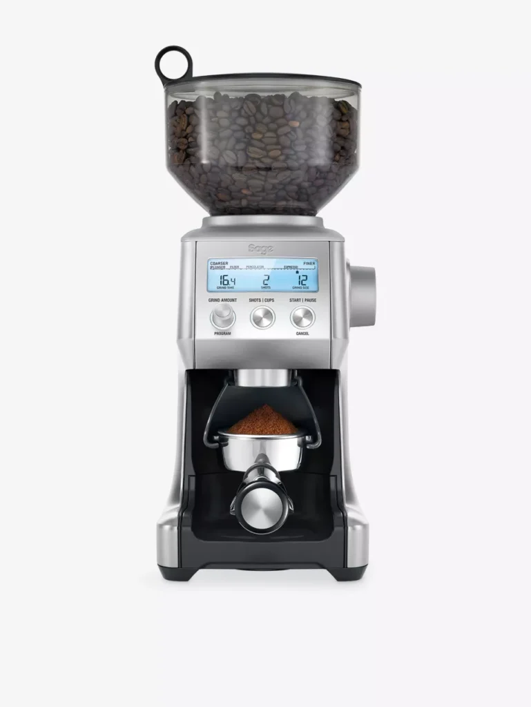 Breville Smart Grinder Pro stainless steel coffee grinder with bean-filled hopper grinding fresh coffee directly into an espresso portafilter, showing LCD dose and grind settings