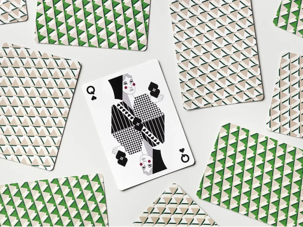 Queen of spades playing card surrounded by PRINTWORKS × Rosewood geometric patterned card backs