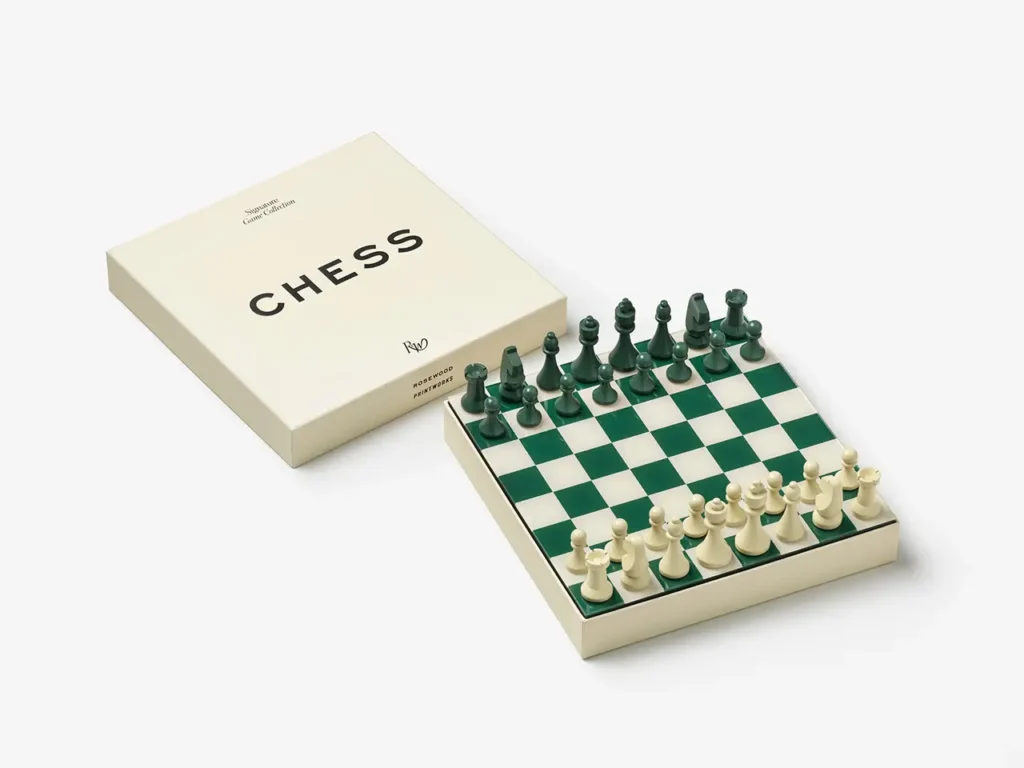 PRINTWORKS × Rosewood chess set with green and cream pieces arranged on a green checkered board next to the chess box