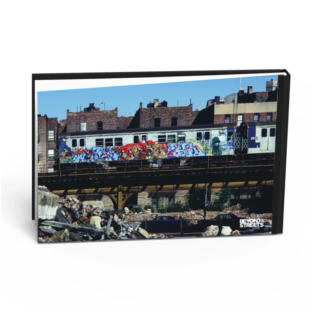 Back cover of Martha Cooper’s Spray Nation book featuring a photograph of a graffiti-covered New York subway train on elevated tracks