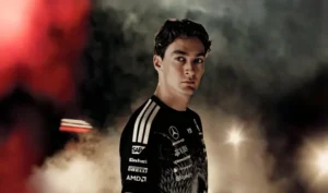 Close-up of George Russell wearing Y-3 x Mercedes-AMG PETRONAS F1 teamwear in smoky, cinematic lighting