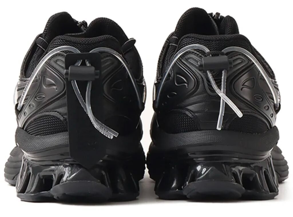 Rear view of the black YOASOBI x ASICS GEL-Kinetic Fluent sneaker featuring Scutoid GEL heel cushioning and transparent lace tubing system