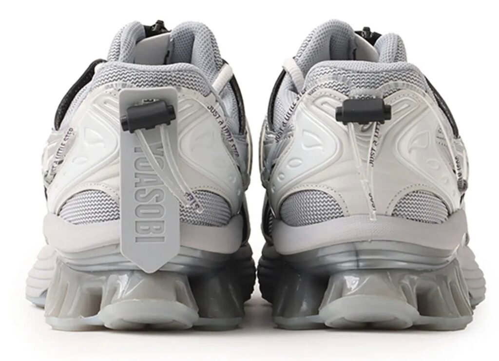 Rear view of the white YOASOBI x ASICS GEL-Kinetic Fluent sneaker featuring Scutoid GEL heel cushioning and technical lace tubing detail