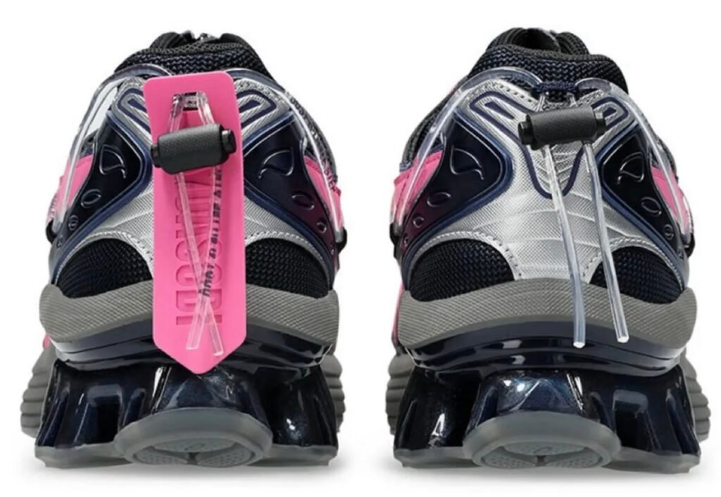 Rear view of the pink and navy YOASOBI x ASICS GEL-Kinetic Fluent sneaker featuring sculpted GEL heel cushioning and co-branded heel tag