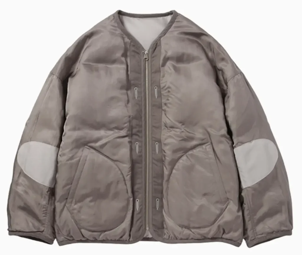 Reversible silver liner down jacket by Visvim WMV featuring goose down insulation, round patch pockets, and contrast elbow panels