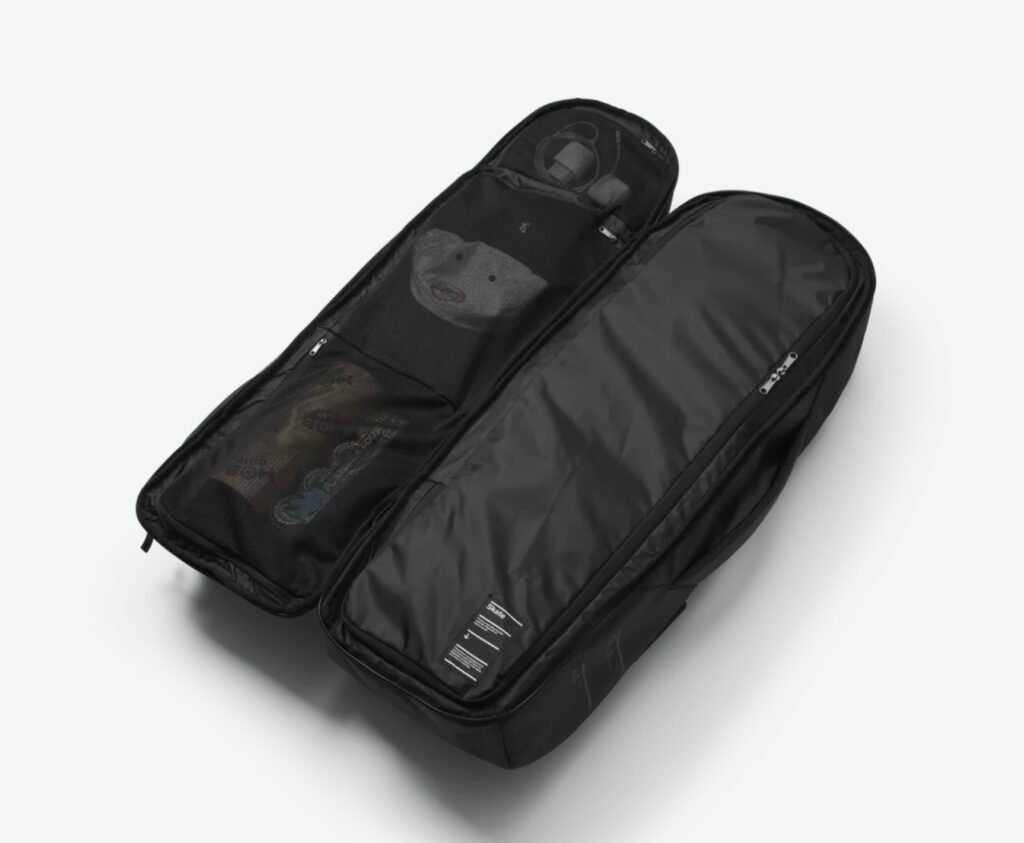 Interior view of the Db Journey Skate Duffel 65L showing its split-duffel layout with mesh organizer pockets and a separate compartment designed to store skateboard decks and travel gear