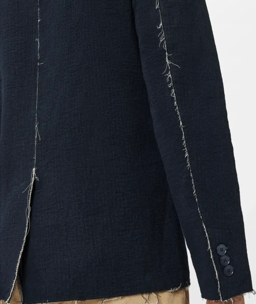 Rear detail of the navy John Varvatos Knox Jacket showing raw edge seam construction, textured double-faced cotton fabric, sleeve buttons, and relaxed unstructured tailoring