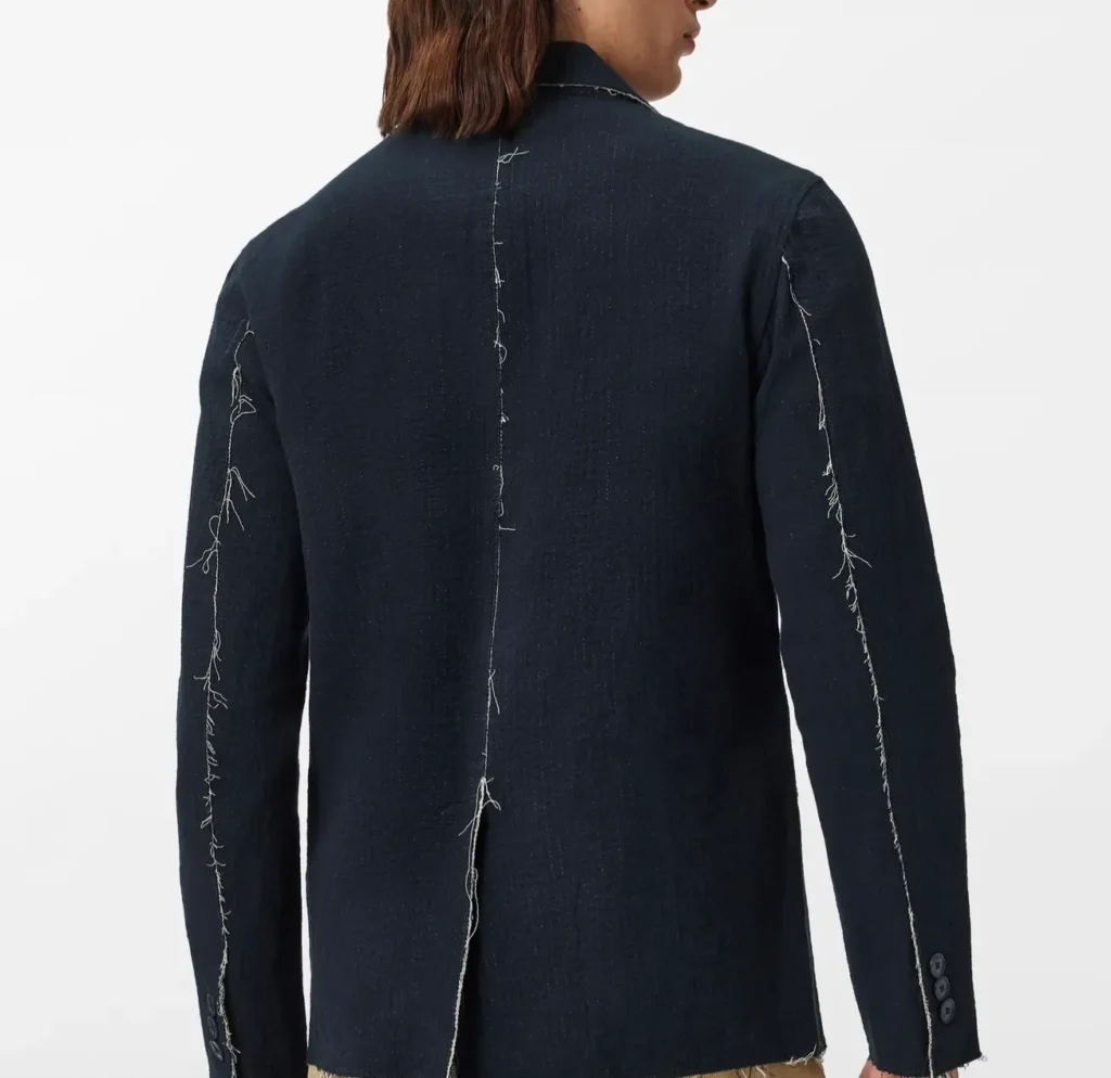 Back view of the navy John Varvatos Knox Jacket featuring exposed raw seam detailing along the center back and sleeves, textured double-faced cotton fabric, and relaxed unstructured tailoring