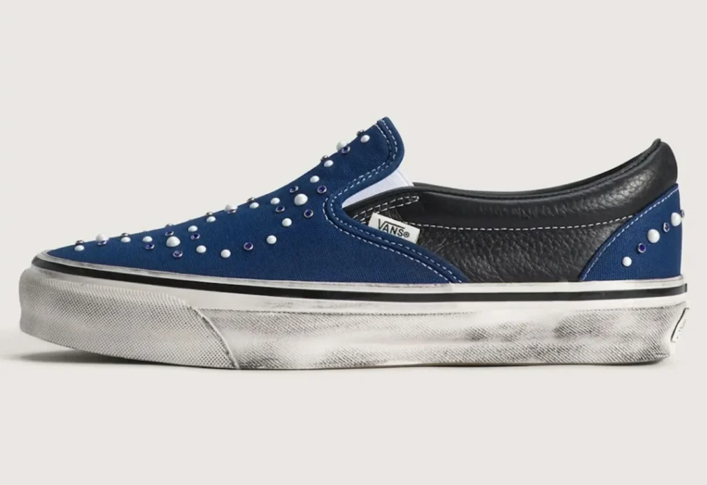 Vans Pearlised Slip-On shoe featuring navy canvas upper with scattered pearl studs and textured black leather heel panel