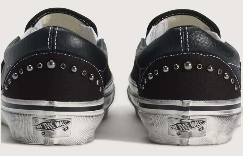 Back view of black Vans Pearlised Slip-On shoes featuring metal stud embellishments on the heel