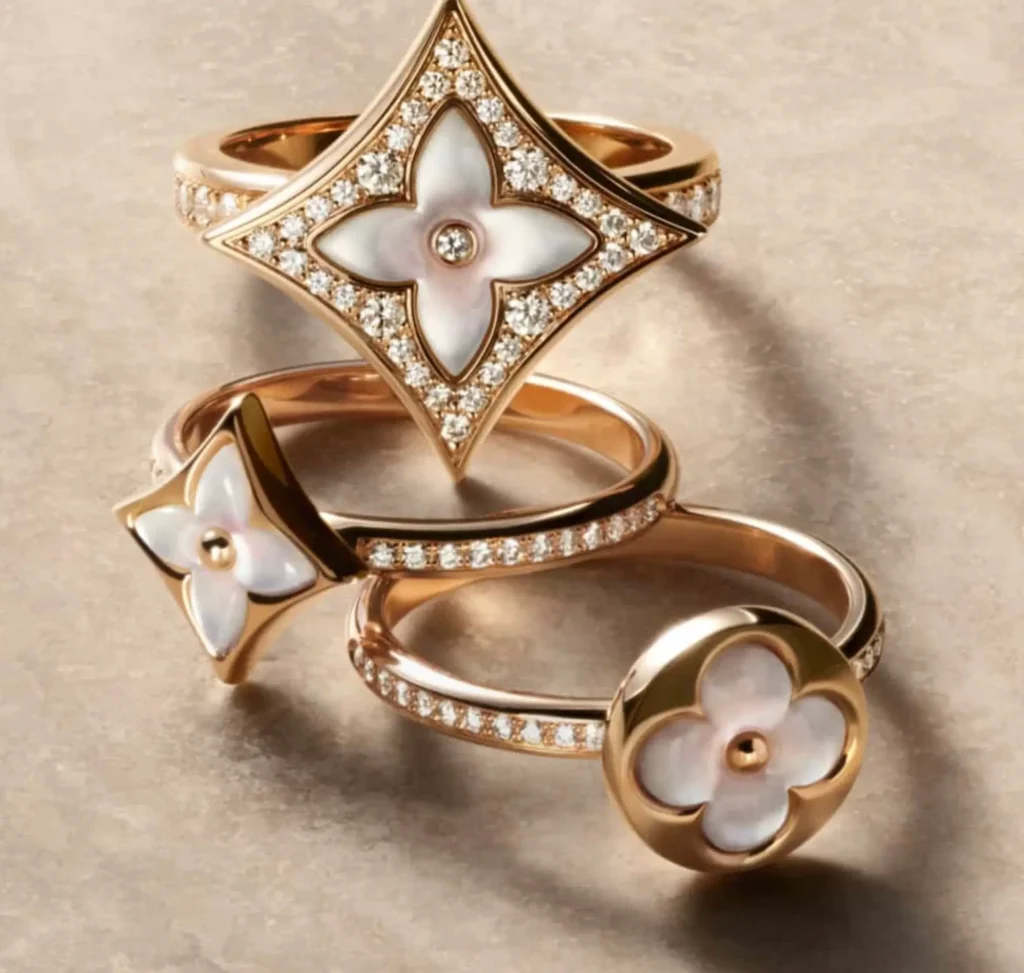 Louis Vuitton Colour Blossom fine jewelry rings featuring monogram flower motifs in mother-of-pearl set in polished gold, accented with pavé diamonds and stacked in a refined composition