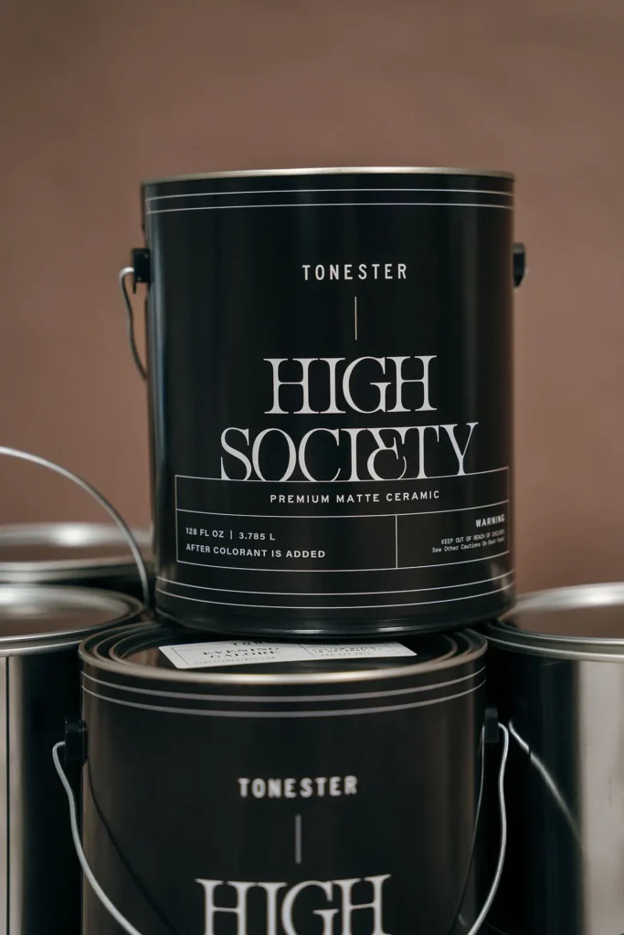 Black Tonester “High Society” premium matte ceramic container designed like a paint can, stacked with matching containers in a studio setting