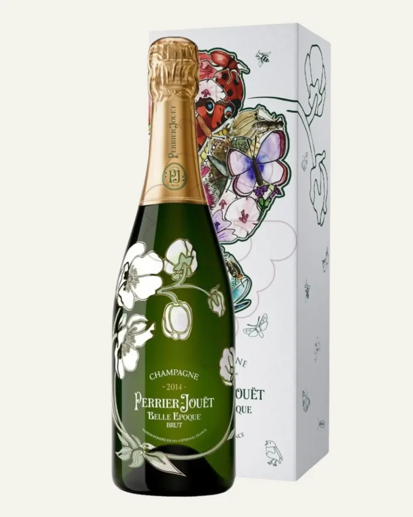 Perrier-Jouët Belle Époque Brut 2014 champagne bottle featuring the iconic white anemone floral design, displayed in front of an illustrated gift box decorated with butterflies, insects, and botanical artwork