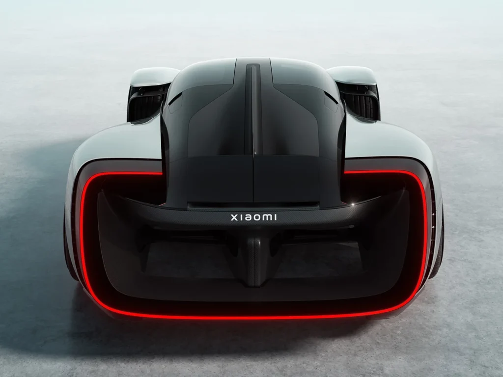 Rear view of the Xiaomi Vision Gran Turismo electric hypercar concept with illuminated red LED light ring and Xiaomi branding across the carbon fiber rear section
