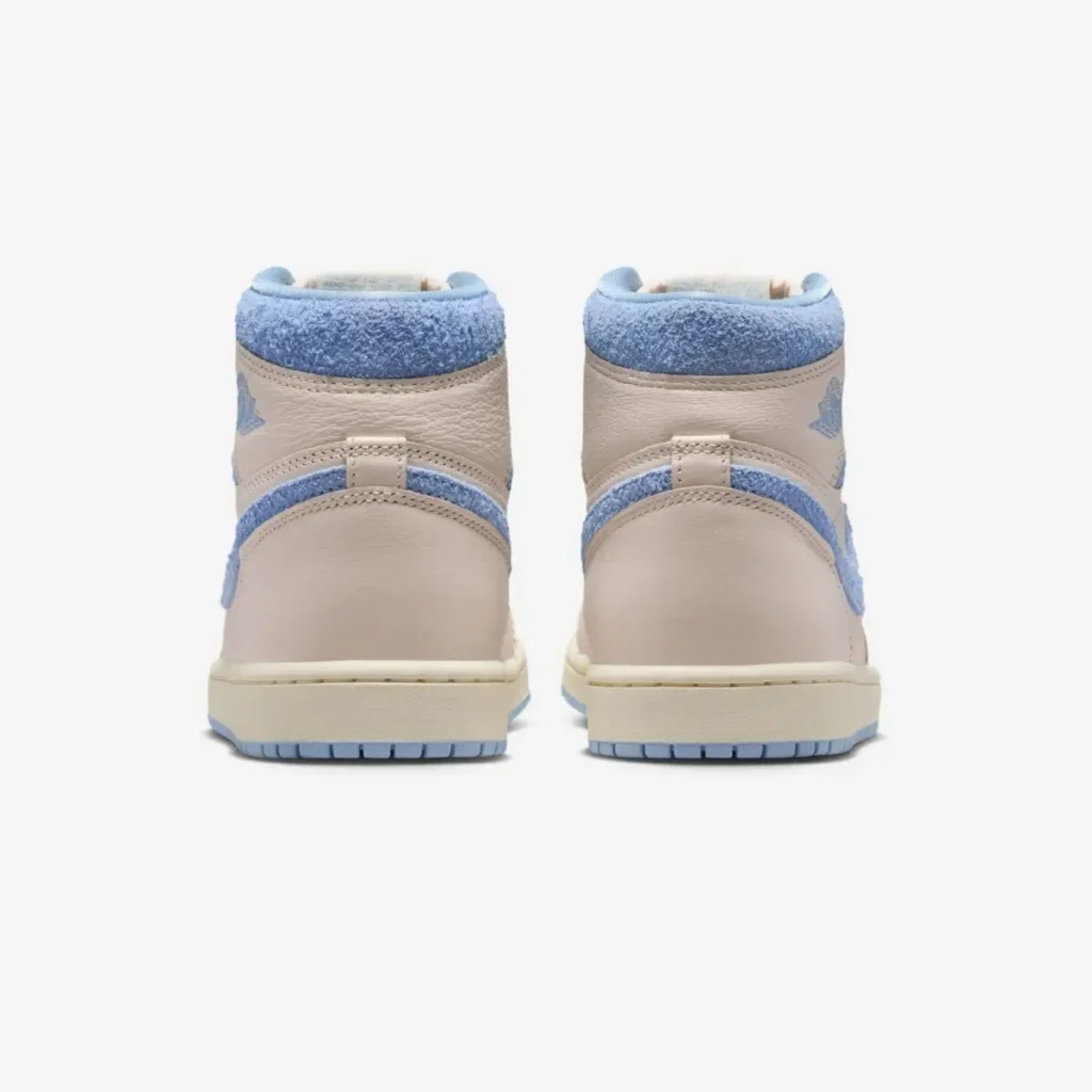 Rear view of the Air Jordan 1 High OG WMNS “Psychic Blue” showing cream leather heel panels, textured pastel blue collar overlays, and light blue outsole