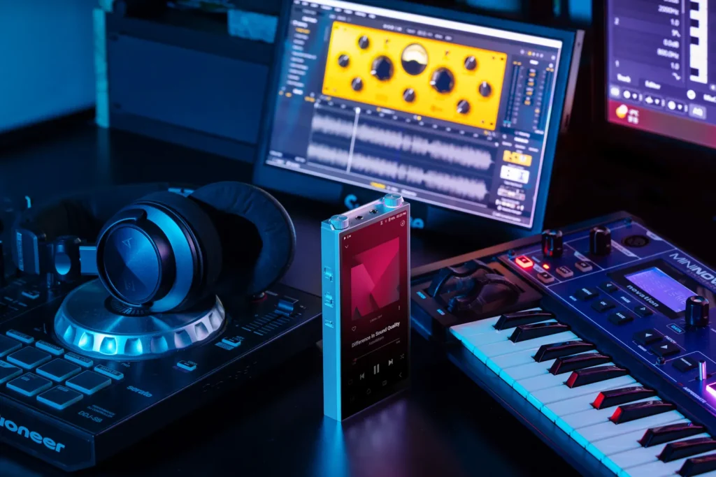 Astell&Kern PD20 portable audio player positioned in a professional music production setup with studio headphones, MIDI keyboard, and audio software interface, highlighting high-fidelity playback in a creative environment