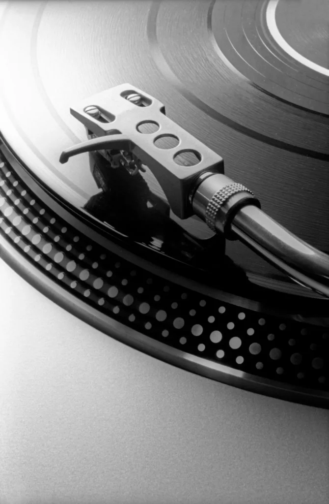 Close-up of Technics turntable needle on vinyl record highlighting precision tonearm and platter detail