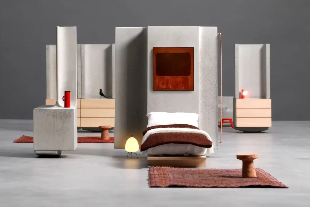 Bedroom setup created with modular concrete components from MIT’s Heirloom House project, showing a bed, lighting, and furniture arranged within movable structural panels