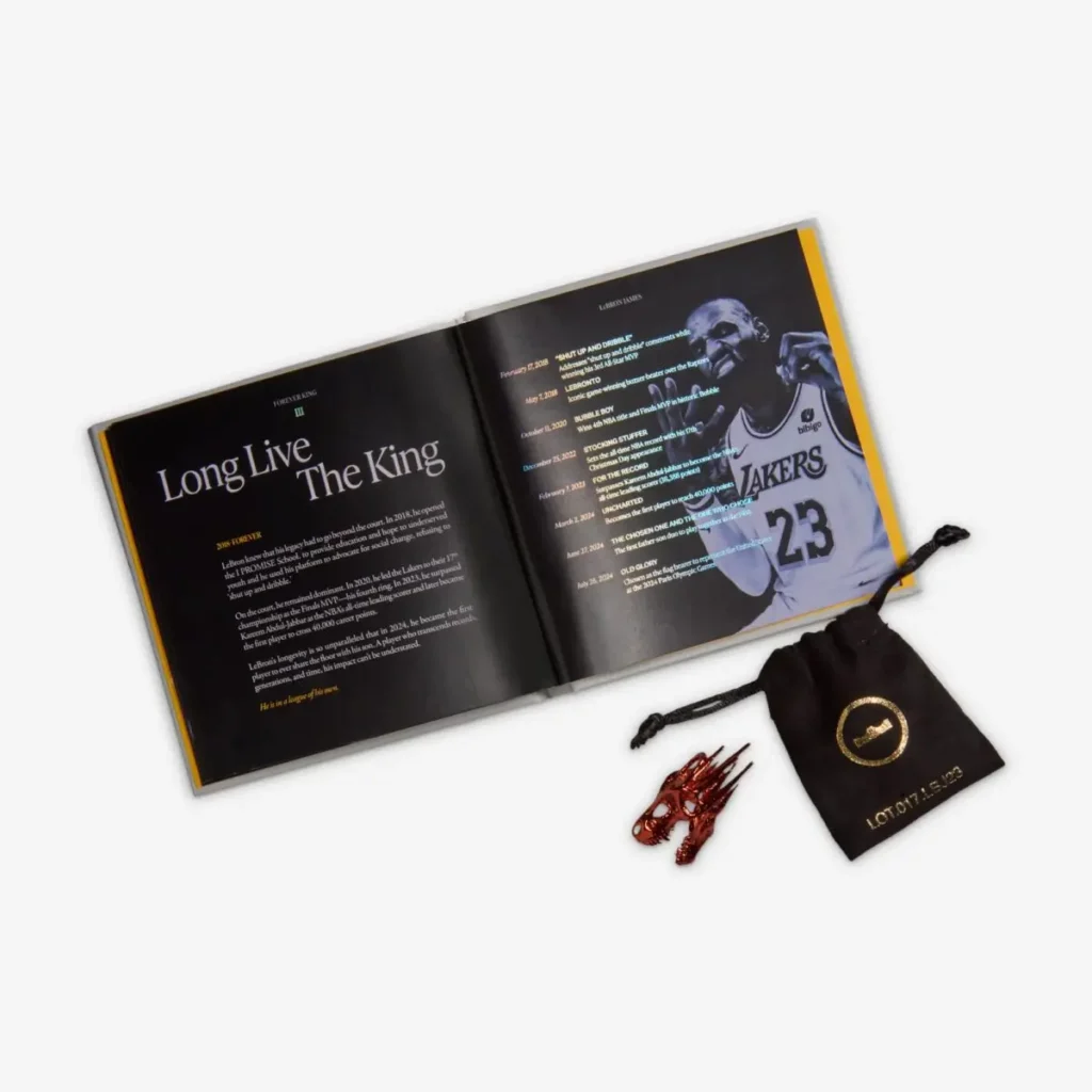 Nike LeBron 23 “LeBronto” packaging contents showing commemorative booklet titled “Long Live The King,” LeBron James imagery, and a black pouch with red crown lace accessories